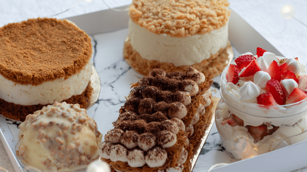 various desserts in a white box on a table