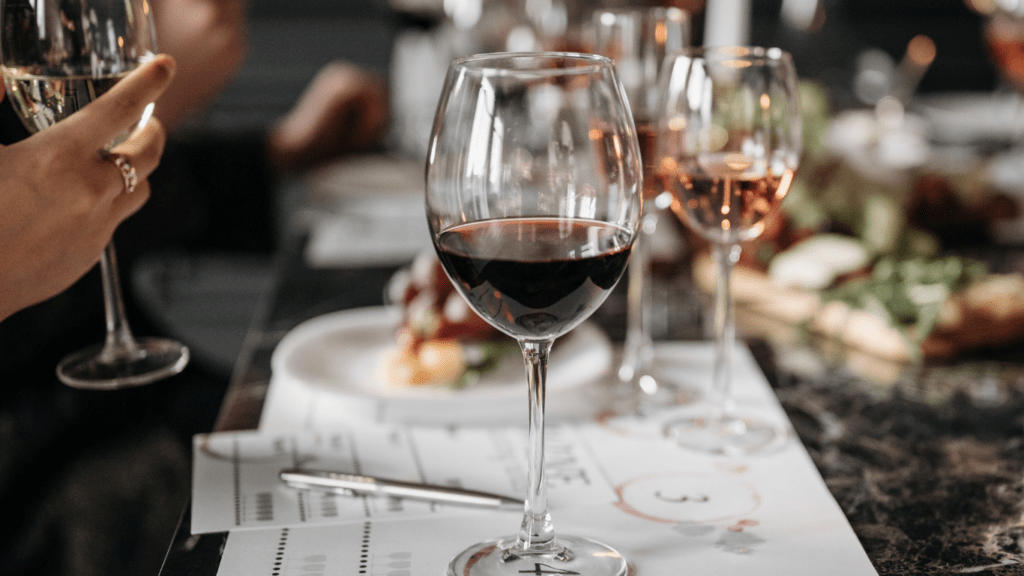 a group of people sitting at a table with wine glasses