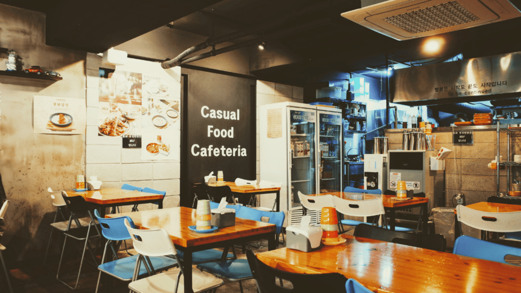 the interior of a restaurant with tables and chairs