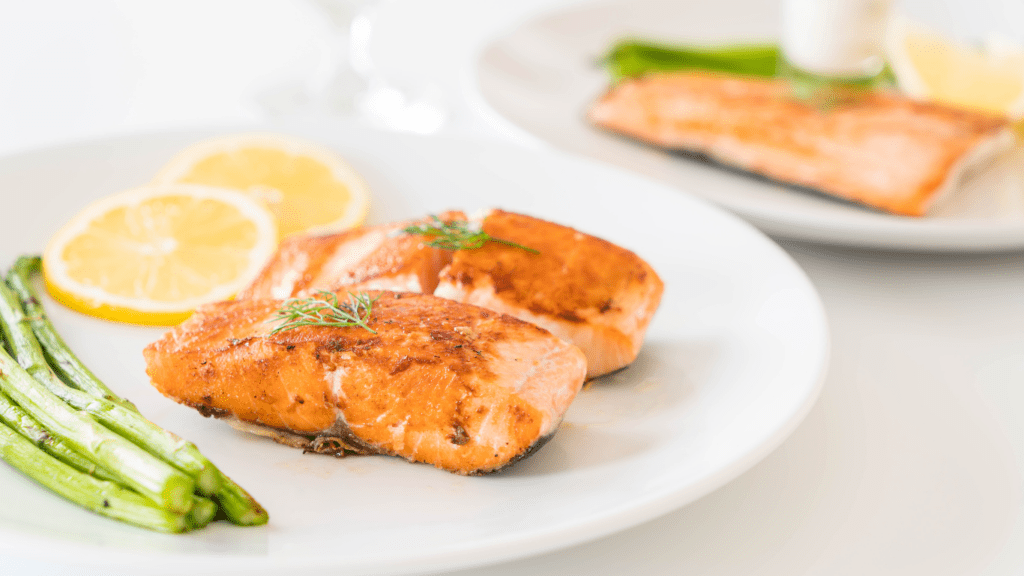 plate with salmon and asparagus on them