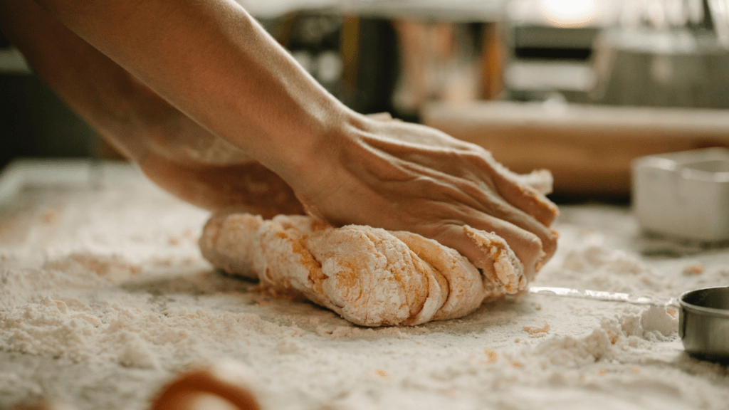 a person is kneading dough on a counter