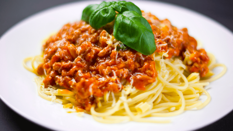 spaghetti with tomato sauce in a white