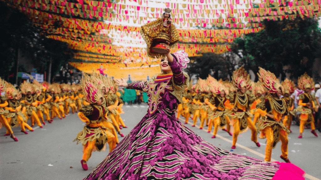 a person in a colorful dress is in the middle of a parade