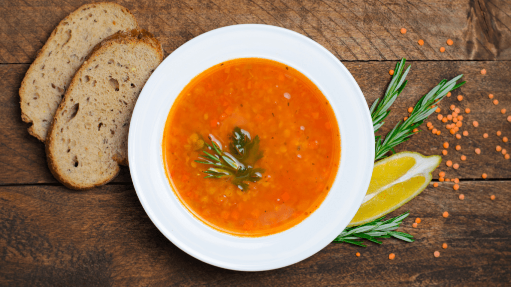 a bowl of soup with a spoon sitting on top of a table