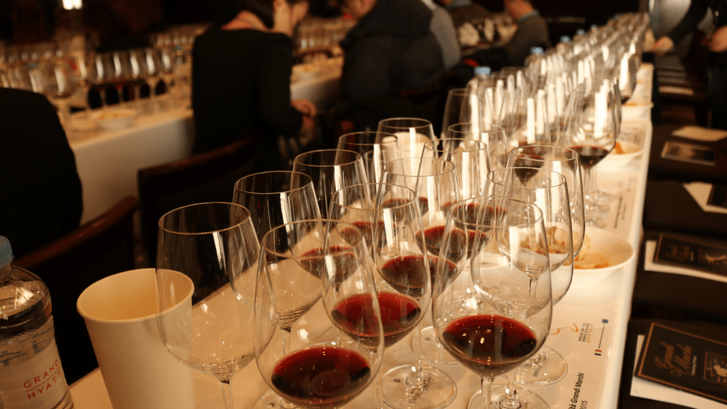 a group of people sitting at a table with wine glasses