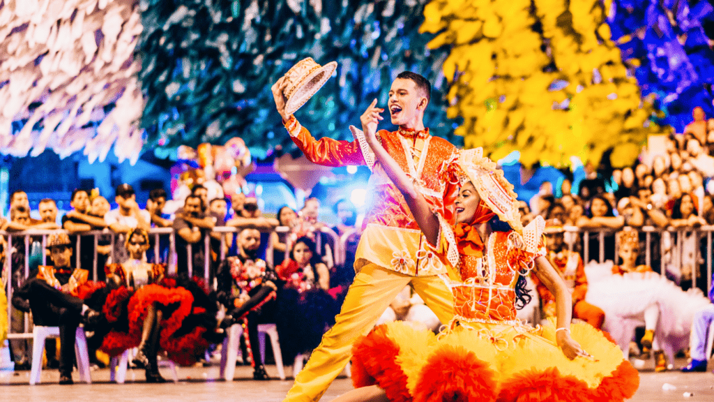 a person in a colorful dress is in the middle of a parade