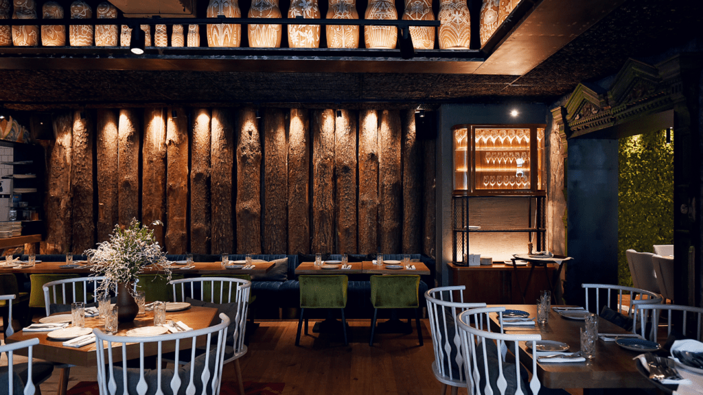 a restaurant with empty tables and empty wine glasses