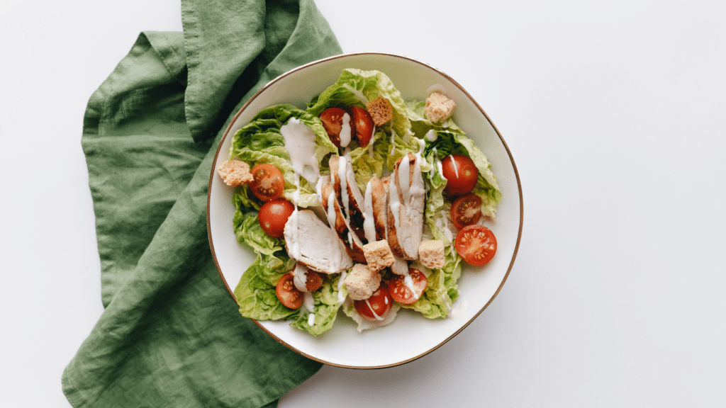 salad with chicken and vegetables in a glass bowl