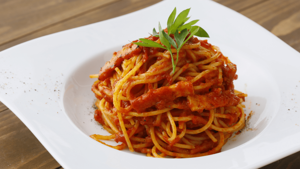 spaghetti with tomato sauce in a white