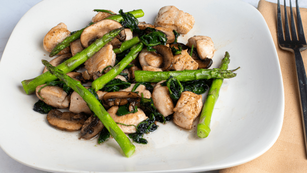 spinach and mushrooms on a white plate